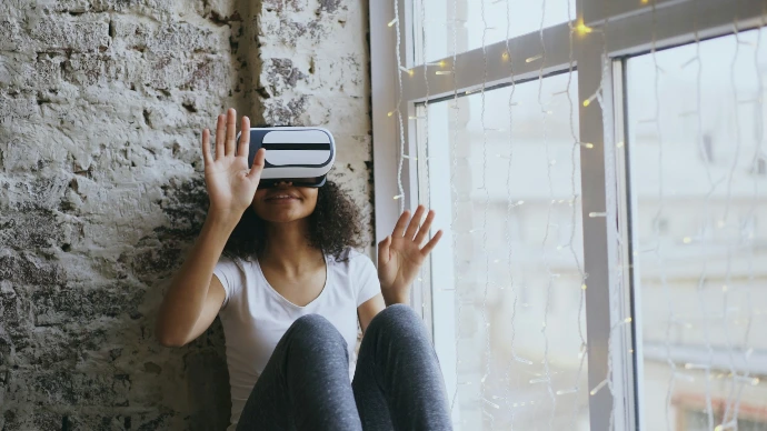 Woman wearing vr headset by a window